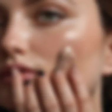 Close-up of a hand applying black spot treatment cream on skin