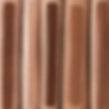 A side-by-side comparison of swatches from high-end and dupe brow pencils.