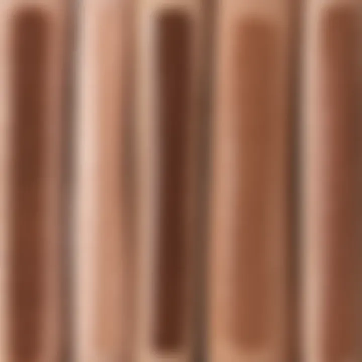 A side-by-side comparison of swatches from high-end and dupe brow pencils.