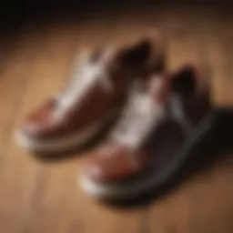 Stylish leather tennis shoes on a wooden surface