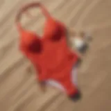Elegant red high cut swimwear on a sandy beach