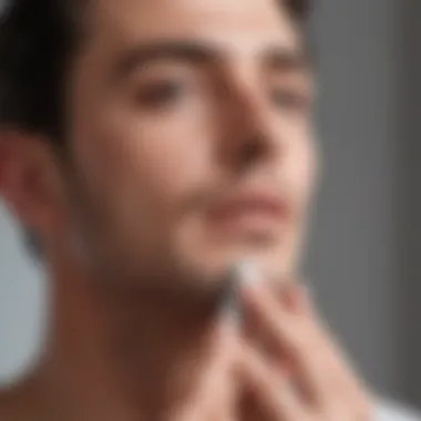 A person applying aftershave lotion after shaving.