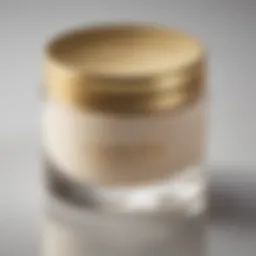 Luxurious cream jar with a golden lid on a reflective surface